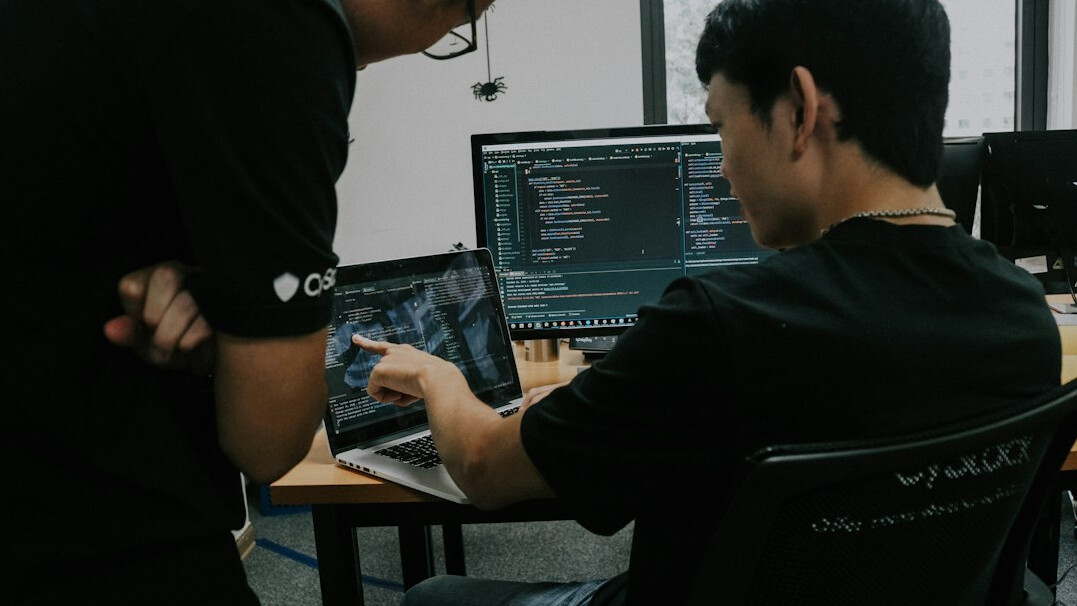 web developer coding on laptop