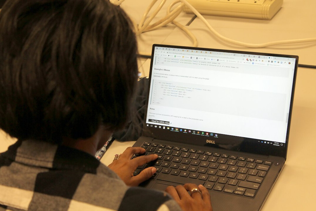 young person coding on laptop