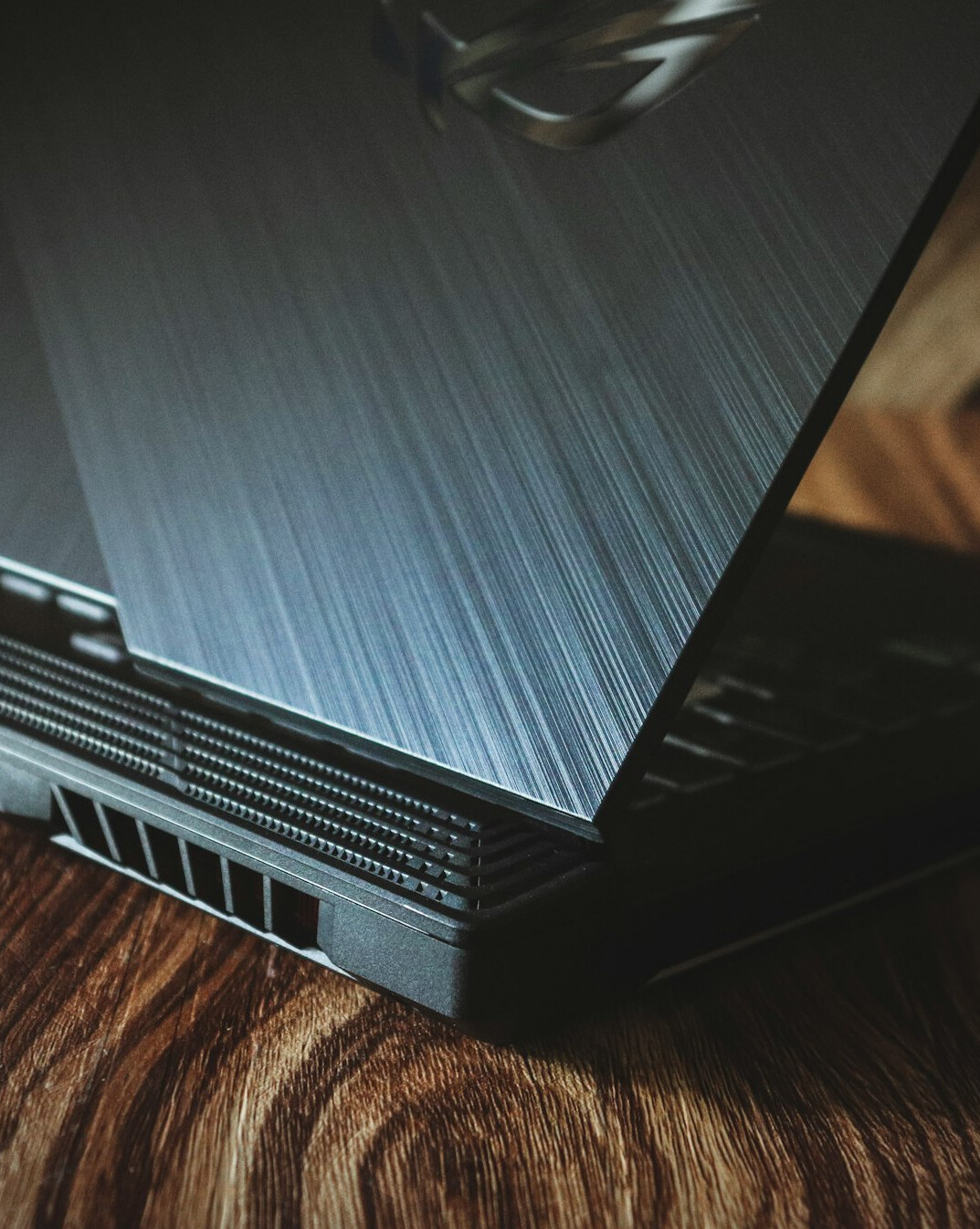 Open notebook and laptop on a desk near a window