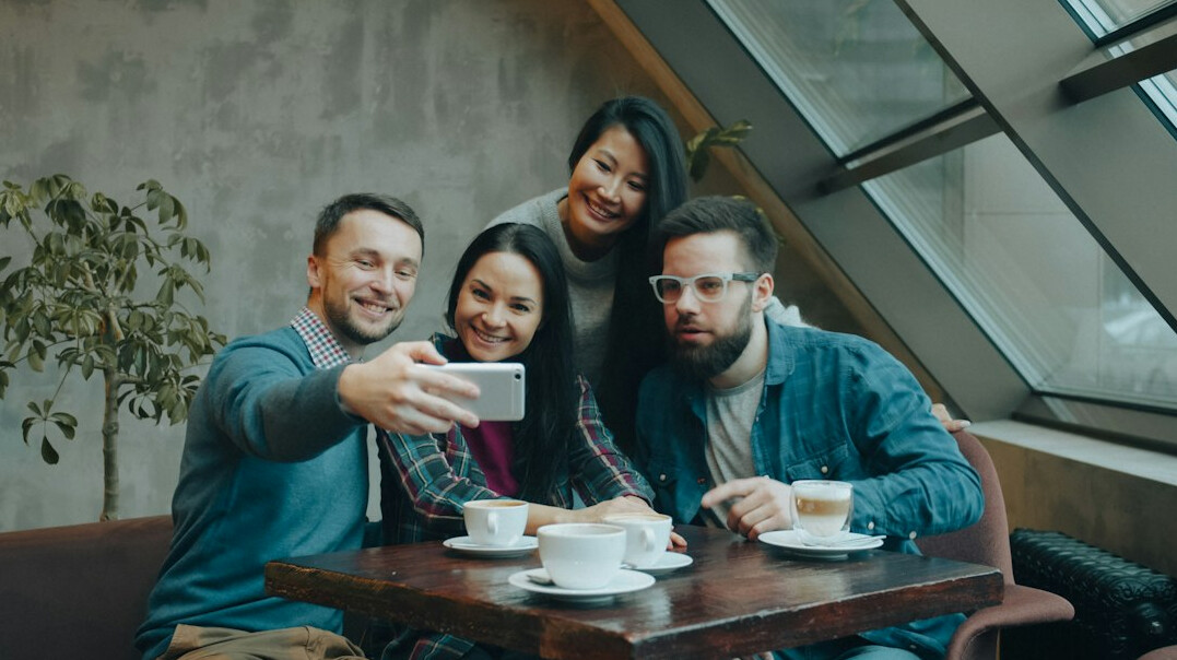 Group of four young Croatian professionals standing together and smiling